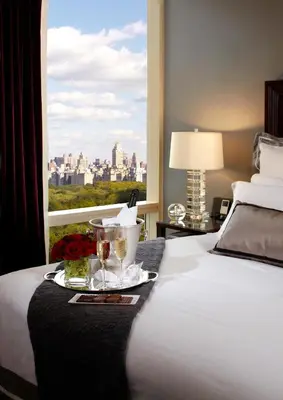 a hotel room with a bed and a window at Trump International New York in New York