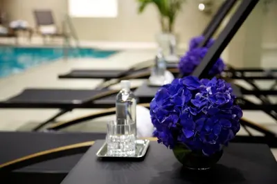 a table with a vase of purple flowers on it at Trump International New York in New York