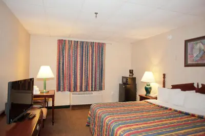 a hotel room with a bed and a television at Days Inn by Wyndham Parsippany in Parsippany