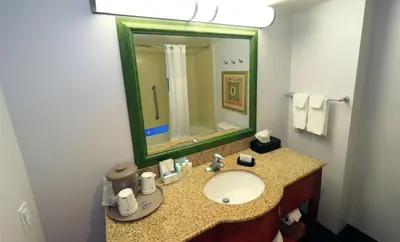 a bathroom with a sink and a mirror at Hampton Inn and Suites of Lamar in Mill Hall