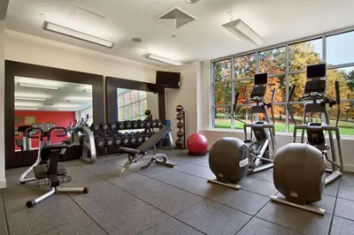 a gym with several treadmills and exercise machines at Hilton Pearl River in Pearl River