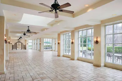 an empty lobby with a ceiling fan and windows at Hilton Pearl River in Pearl River