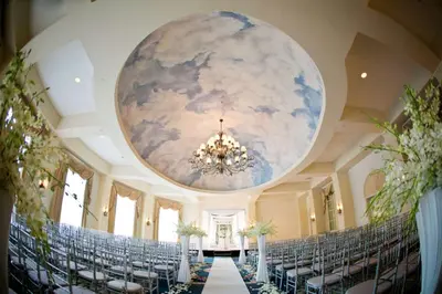 a ballroom with chairs and a ceiling with a mural at Hilton Pearl River in Pearl River