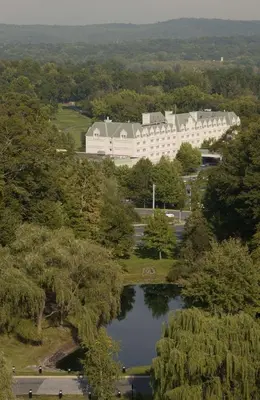 an aerial view of a large building with a lake at Hilton Pearl River in Pearl River