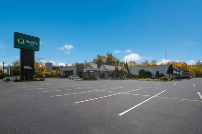 a parking lot in front of a car dealership at Quality Inn Wayne - Fairfield Area in Wayne