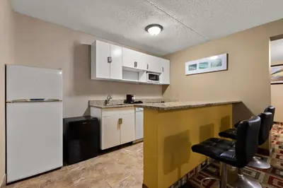 a kitchen with a counter and a refrigerator at Quality Inn Wayne - Fairfield Area in Wayne