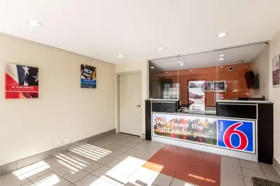 a room with a sign on the wall at Motel 6 New Brunswick in New Brunswick