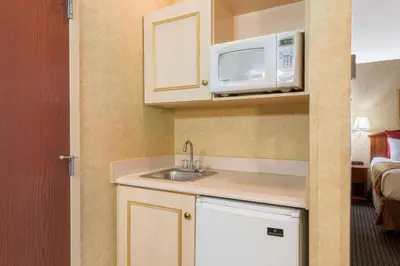 a small kitchen with a sink and a microwave at Lancaster Suites in Lancaster