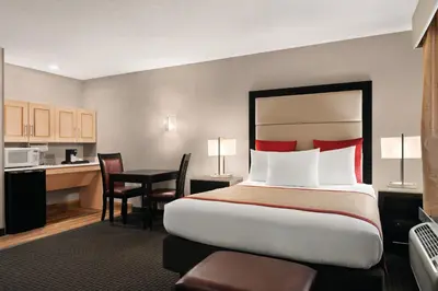a hotel room with a large bed and a desk at Lancaster Suites in Lancaster