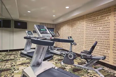 a gym with two exercise bikes and a phone at La Quinta by Wyndham Lancaster in Lancaster