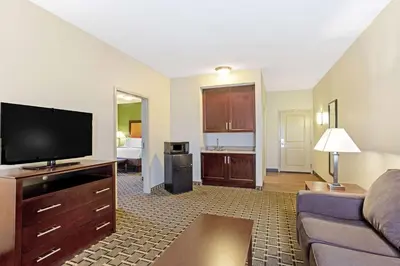 a living room with a couch and a flat screen tv at La Quinta by Wyndham Lancaster in Lancaster
