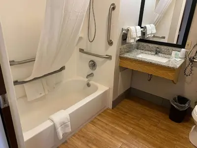 a bathroom with a tub and a sink at Motel 6 Lancaster in Lancaster