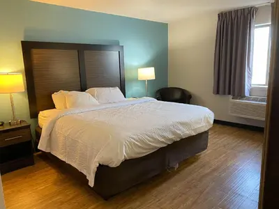 a hotel room with a large bed and a window at Motel 6 Lancaster in Lancaster