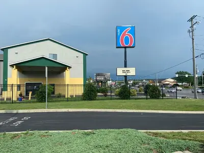 a gas station with a sign on the side of the road at Motel 6 Lancaster in Lancaster