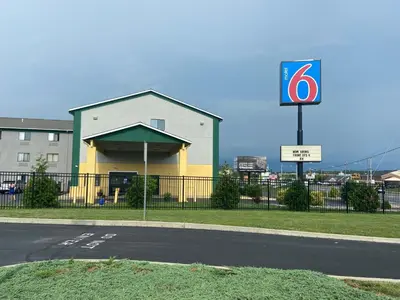 a building with a sign on the side of a road at Motel 6 Lancaster in Lancaster