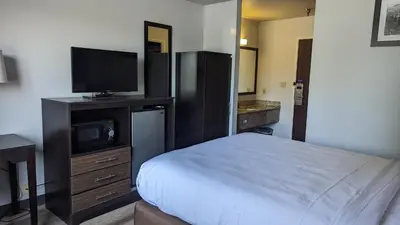 a bedroom with a bed and a flat screen tv at Motel 6 Lancaster in Lancaster