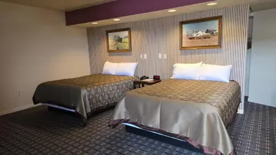 a hotel room with two beds in a room at Classic Inn Lancaster in Lancaster