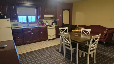 a kitchen and dining room with a table and chairs at Classic Inn Lancaster in Lancaster