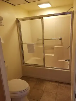 a bathroom with a shower and a toilet at Classic Inn Lancaster in Lancaster
