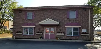 a red brick house with a purple door at Classic Inn Lancaster in Lancaster