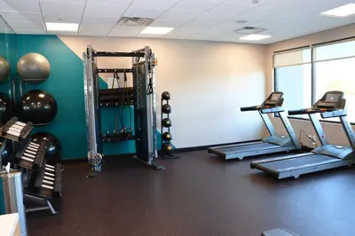 a gym with several treadmills and cardio machines at avid hotels - Lancaster by IHG in Lancaster