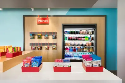 a store with a counter with a drink refrigerator at avid hotels - Lancaster by IHG in Lancaster