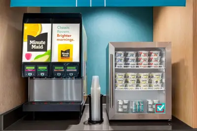 a refrigerator and a drink dispenser in a store at avid hotels - Lancaster by IHG in Lancaster