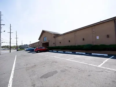 a parking lot with a car parked next to a building at Knights Inn South Amboy in South Amboy