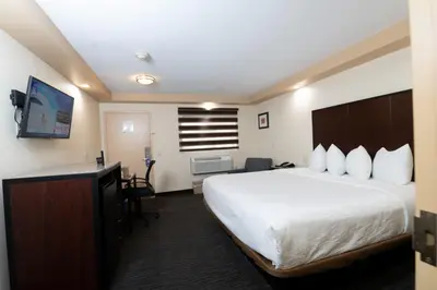 a hotel room with a bed and a television at Knights Inn South Amboy in South Amboy