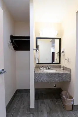 a bathroom with a sink and a mirror at Knights Inn South Amboy in South Amboy