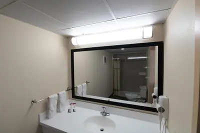 a bathroom with a sink and a large mirror at Knights Inn South Amboy in South Amboy