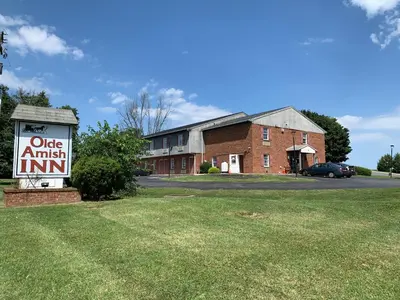 a sign in the grass in front of a building at Olde Amish Inn in Ronks