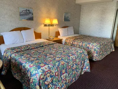 a hotel room with two beds and two lamps at Olde Amish Inn in Ronks