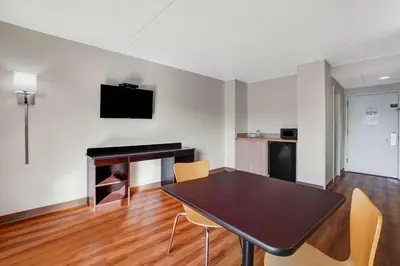 a dining room with a table and a fireplace at Motel 6-Lawrenceville, NJ in Lawrenceville