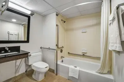 a bathroom with a toilet and a tub and a sink at Motel 6-Lawrenceville, NJ in Lawrenceville
