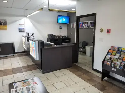 a waiting area of a store with a cash counter at Motel 6-Lawrenceville, NJ in Lawrenceville