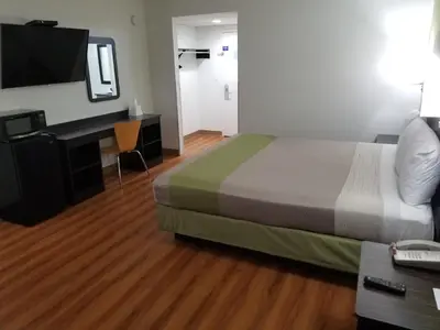 a hotel room with a bed and a desk with a computer at Motel 6-Lawrenceville, NJ in Lawrenceville