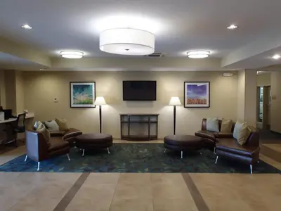 a waiting room with couches and a flat screen tv at Candlewood Suites Bensalem - Philadelphia Area by IHG in Bensalem