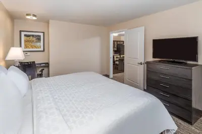 a bedroom with a bed and a flat screen tv at Candlewood Suites Bensalem - Philadelphia Area by IHG in Bensalem