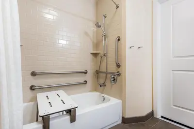 a bathroom with a white tub and a shower at Candlewood Suites Bensalem - Philadelphia Area by IHG in Bensalem