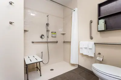 a bathroom with a shower and a toilet at Candlewood Suites Bensalem - Philadelphia Area by IHG in Bensalem
