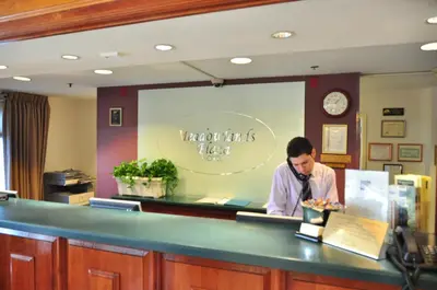 a man standing at the counter of a restaurant at Meadowlands Plaza Hotel in Secaucus