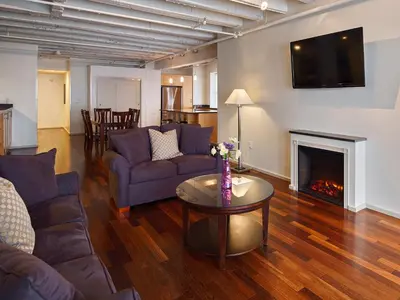 a living room with a couch and a fireplace at Grand Eastonian Hotel & Suites in Easton