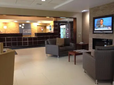 a waiting room with couches and a flat screen tv at Holiday Inn Express Hotel & Suites West Chester by IHG in West Chester
