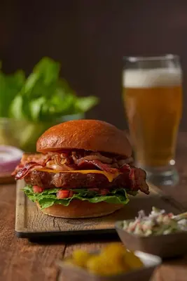 a sandwich on a table with a glass of beer at Hyatt Place Bethlehem-Downtown in Bethlehem