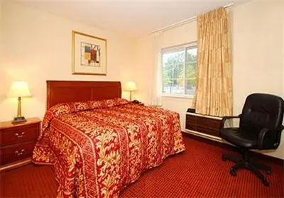 a hotel room with a bed and a chair at Inn at Monticello in Monticello