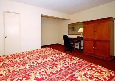 a hotel room with a large bed and a desk at Inn at Monticello in Monticello