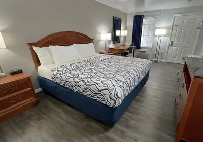 a hotel room with a bed and a desk at America's Best Value Inn Lancaster in Lancaster