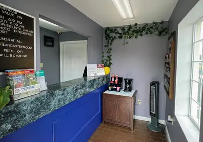 a restaurant with a blue counter and a sign on the wall at America's Best Value Inn Lancaster in Lancaster