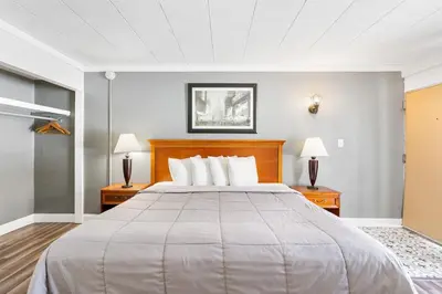 a large bed in a room with two lamps at FairBridge Inn and Suites West Point in Highland Falls